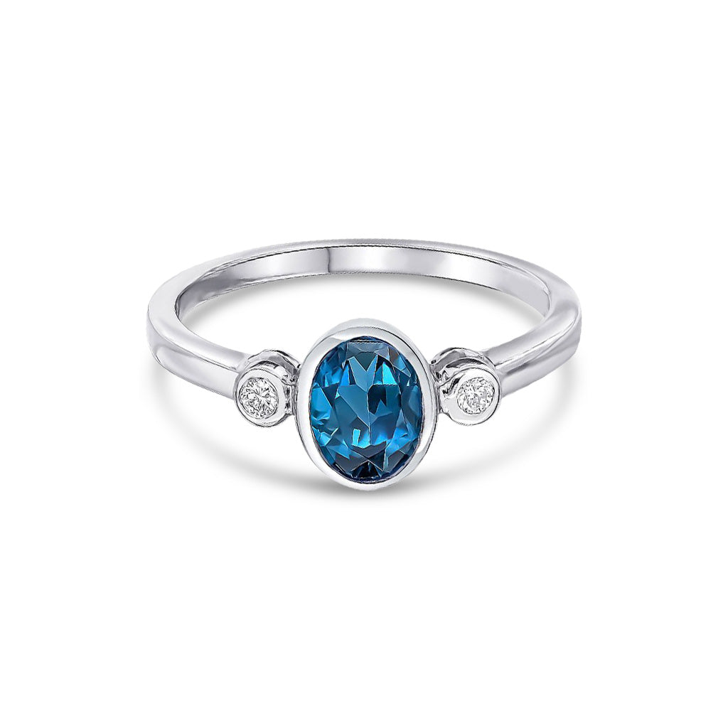 9ct White Gold Oval  Natural London Blue Topaz and Round Diamond Rubover Three Stone Ring — 7x5mm