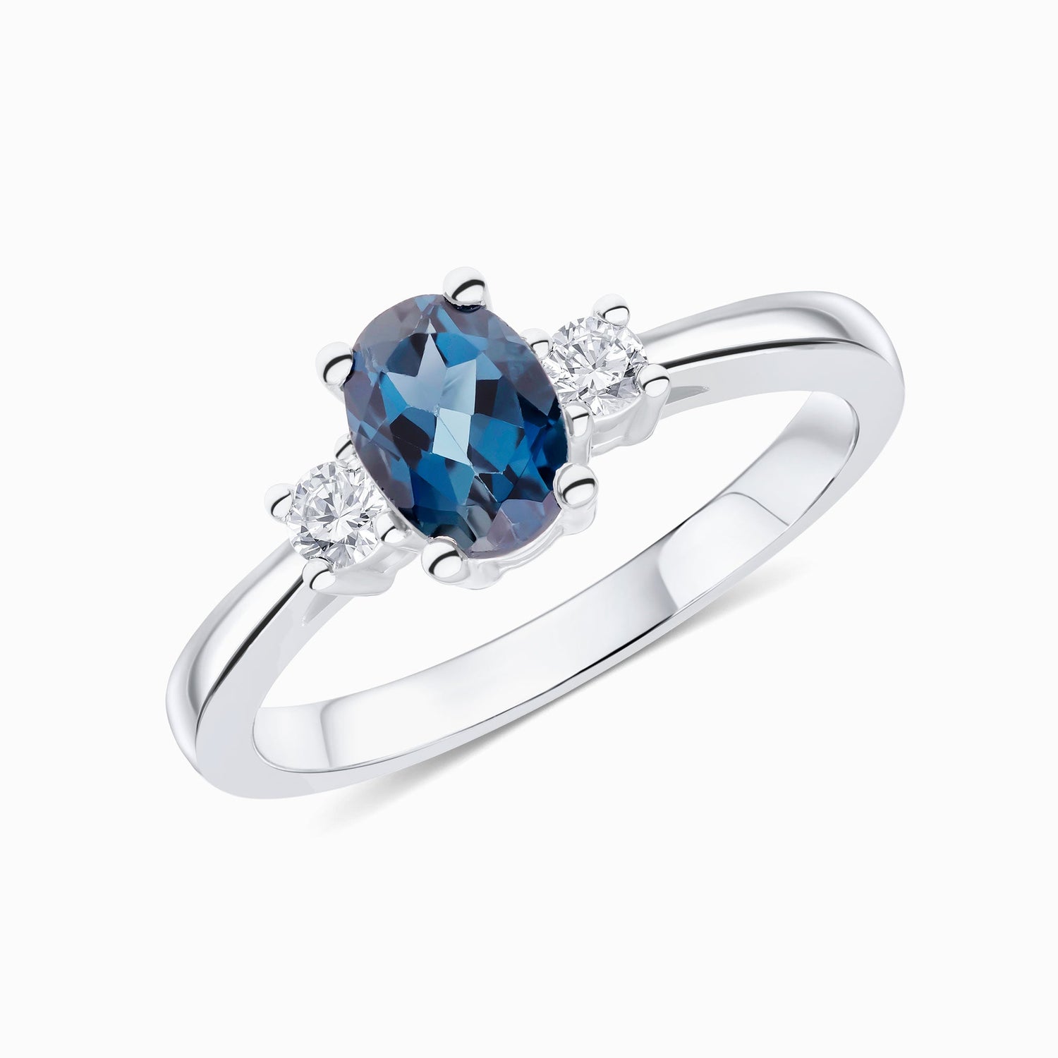 9ct White Gold Oval Natural London Blue Topaz and Round Diamond Claw Set Three Stone Ring — 7x5mm
