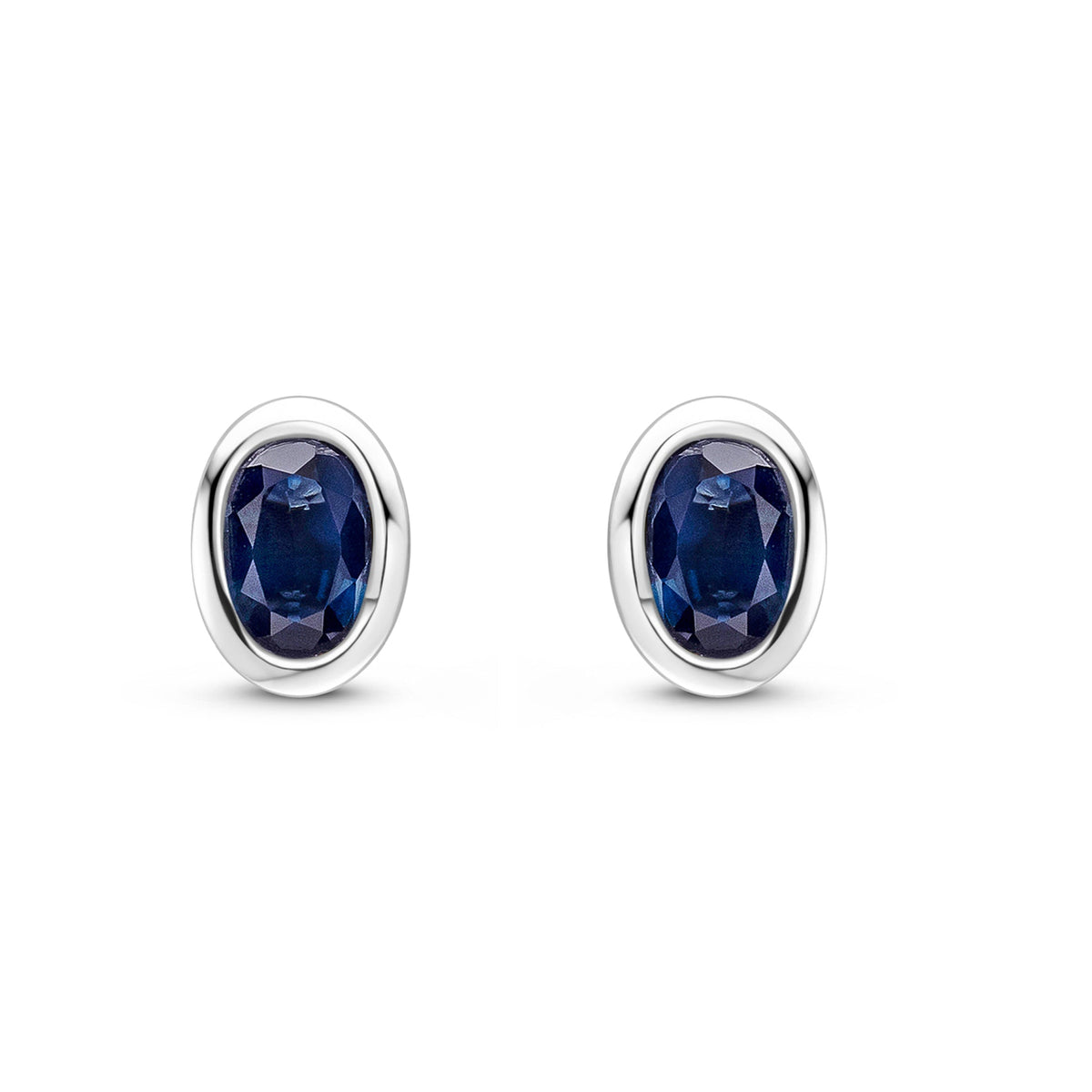 9ct White Gold Oval Natural Sapphire Rubover Stud Earrings — 4x3mm
