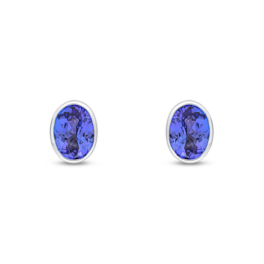9ct White Gold Oval Natural Tanzanite Rubover Stud Earrings — 7x5mm