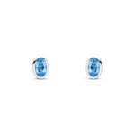 9ct White Gold Oval Natural Swiss Blue Topaz Rubover Stud Earrings — 5x3mm