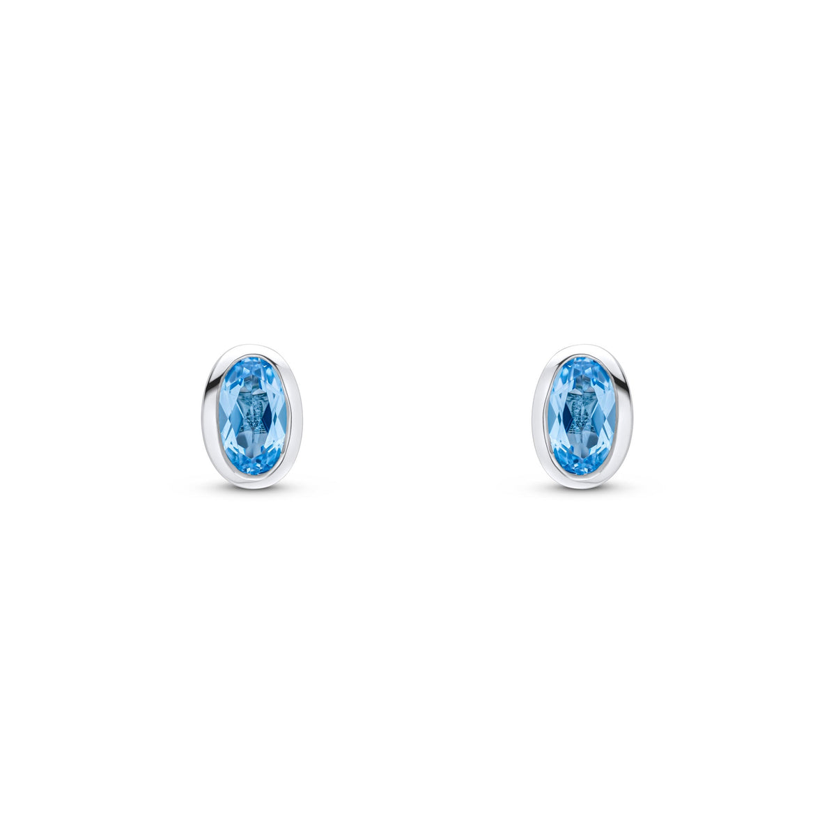 9ct White Gold Oval Natural Swiss Blue Topaz Rubover Stud Earrings — 5x3mm