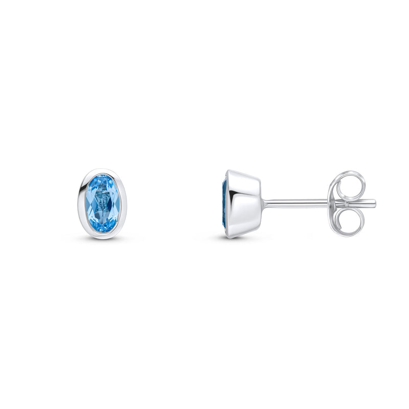 9ct White Gold Oval Natural Swiss Blue Topaz Rubover Stud Earrings — 5x3mm