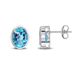 9ct White Gold Oval Natural Swiss Blue Topaz Rubover Stud Earrings — 9x7mm