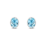 9ct White Gold Oval Natural Swiss Blue Topaz Rubover Stud Earrings — 8x6mm