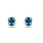 9ct White Gold Oval Natural London Blue Topaz Rubover Stud Earrings — 4x3mm
