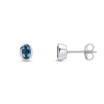 9ct White Gold Oval Natural London Blue Topaz Rubover Stud Earrings — 5x3mm