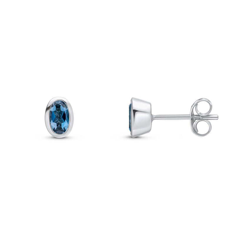 9ct White Gold Oval Natural London Blue Topaz Rubover Stud Earrings — 5x3mm