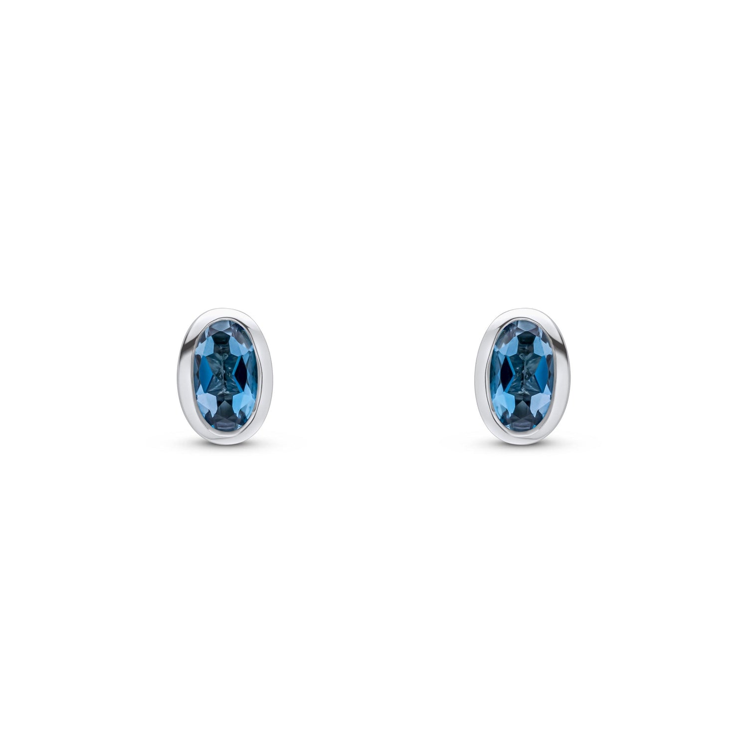 9ct White Gold Oval Natural London Blue Topaz Rubover Stud Earrings — 5x3mm
