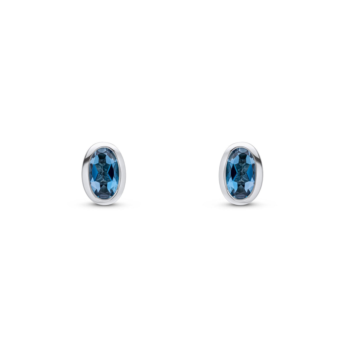 9ct White Gold Oval Natural London Blue Topaz Rubover Stud Earrings — 5x3mm