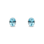 9ct White Gold Oval Natural Swiss Blue Topaz Rubover Stud Earrings — 7x5mm