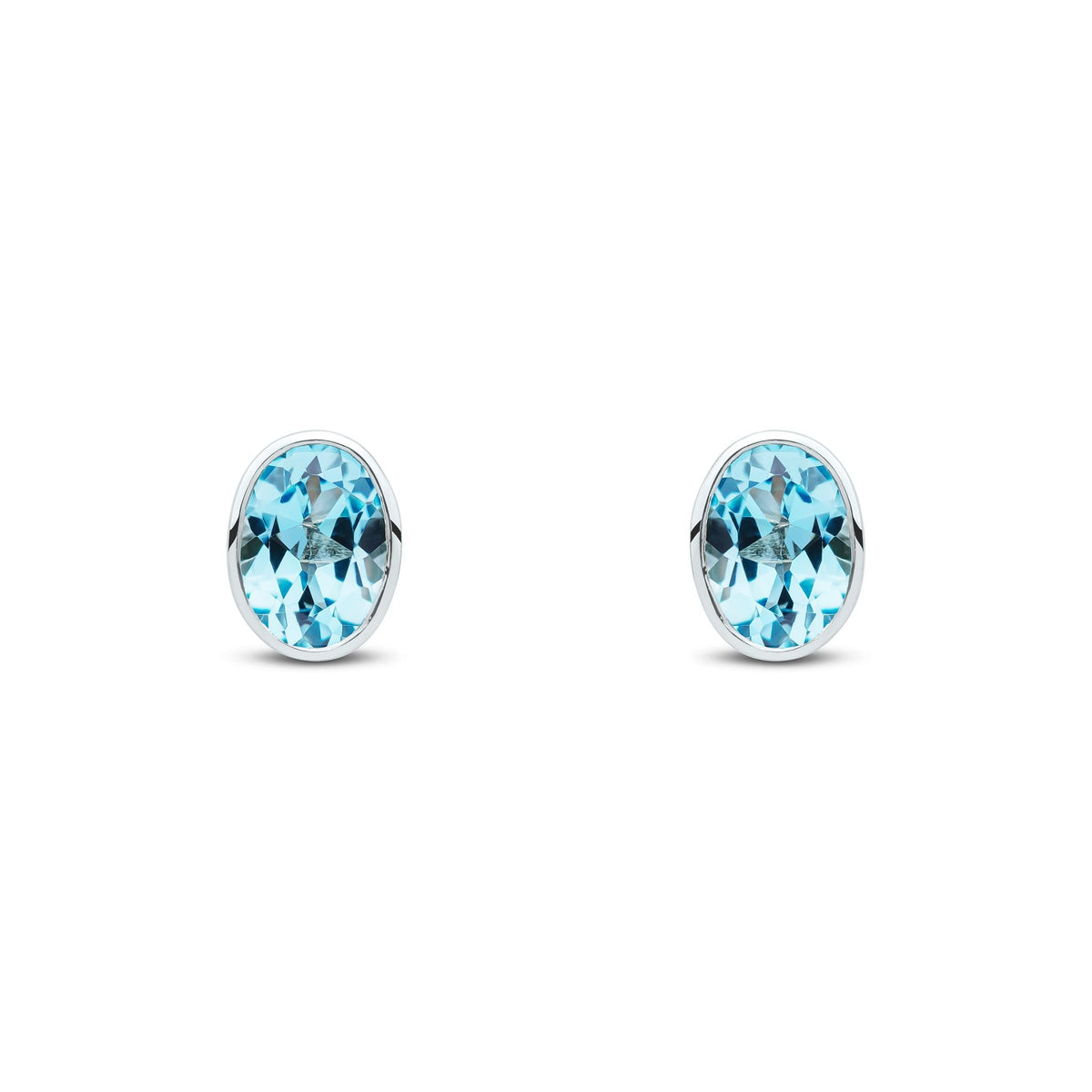 9ct White Gold Oval Natural Swiss Blue Topaz Rubover Stud Earrings — 7x5mm