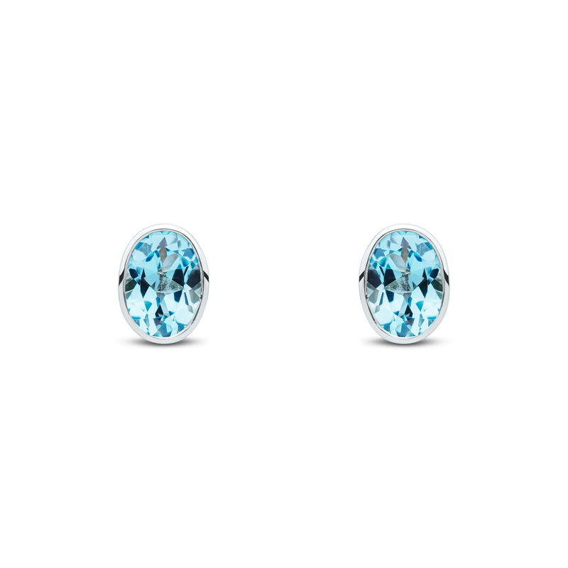 9ct White Gold Oval Natural Swiss Blue Topaz Rubover Stud Earrings — 7x5mm
