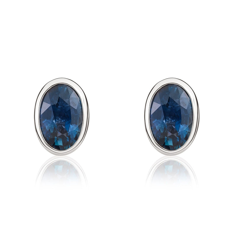 9ct White Gold Oval Natural Sapphire Rubover Stud Earrings — 6x4mm