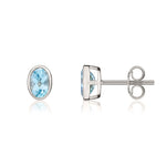 9ct White Gold Oval Natural Swiss Blue Topaz Rubover Stud Earrings — 6x4mm