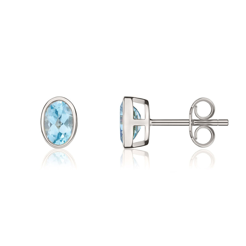 9ct White Gold Oval Natural Swiss Blue Topaz Rubover Stud Earrings — 6x4mm