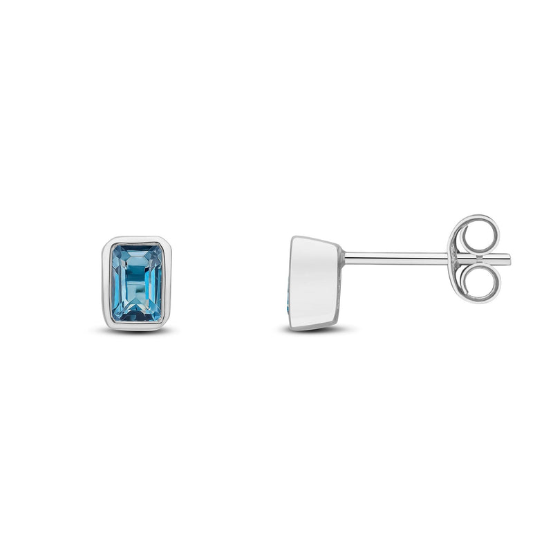 9ct White Gold Octagonal Emerald Cut Natural London Blue Topaz Rubover Stud Earrings — 5x3mm