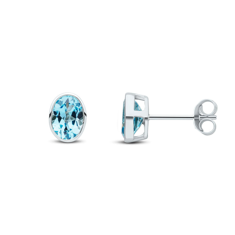 9ct White Gold Oval Natural Swiss Blue Topaz Rubover Stud Earrings — 7x5mm