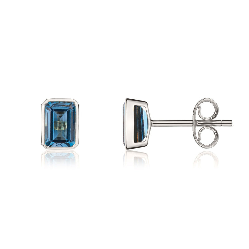 9ct White Gold Octagonal Emerald Cut Natural London Blue Topaz Rubover Stud Earrings — 7x5mm
