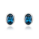 9ct White Gold Oval Natural London Blue Topaz Rubover Stud Earrings — 6x4mm