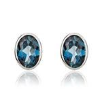9ct White Gold Oval Natural London Blue Topaz Rubover Stud Earrings — 7x5mm