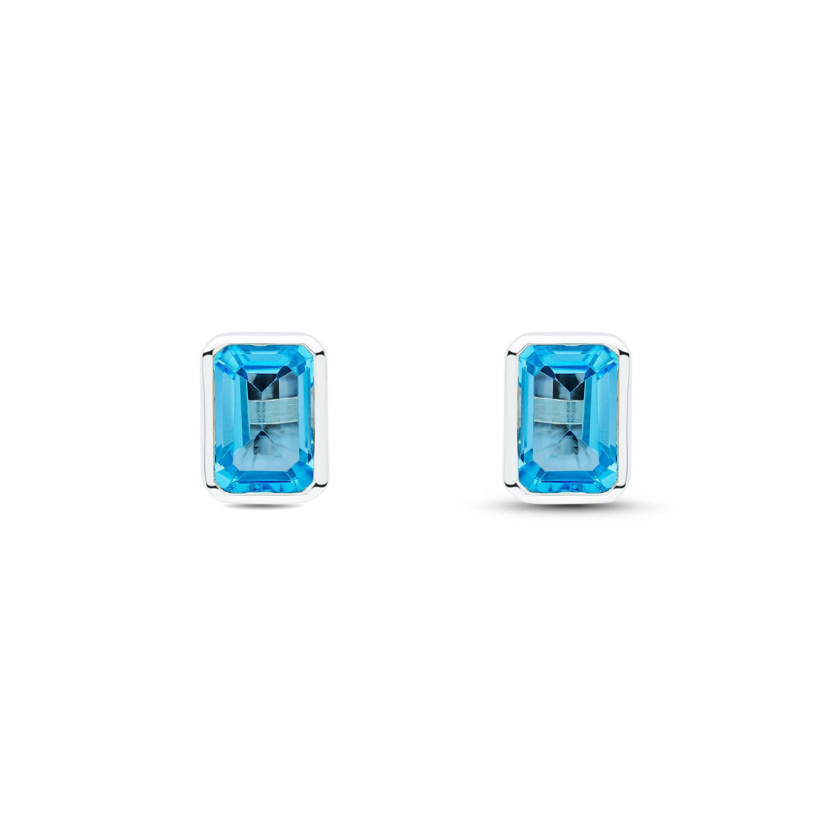 9ct White Gold Octagonal Emerald Cut Natural Swiss Blue Topaz Rubover Stud Earrings — 7x5mm