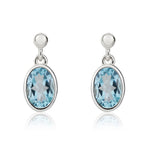 9ct White Gold Oval Natural Swiss Blue Topaz Rubover Drop Earrings — 7x5mm