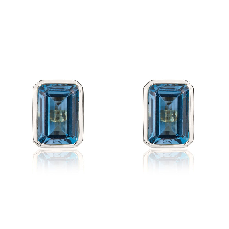9ct White Gold Octagonal Emerald Cut Natural London Blue Topaz Rubover Stud Earrings — 7x5mm