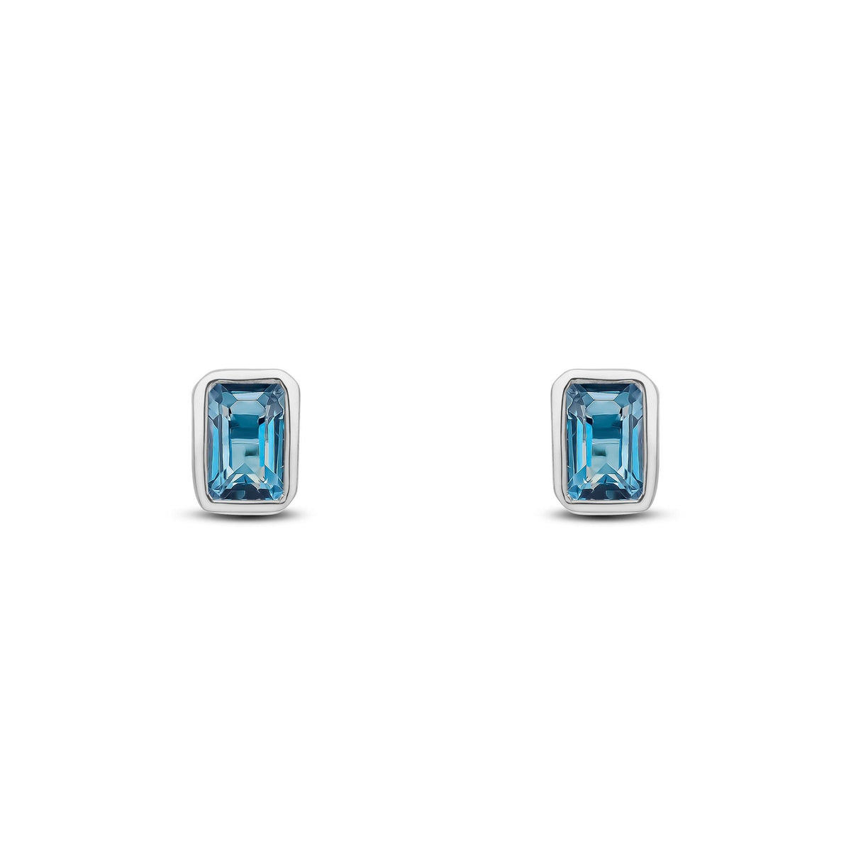 9ct White Gold Octagonal Emerald Cut Natural London Blue Topaz Rubover Stud Earrings — 5x3mm